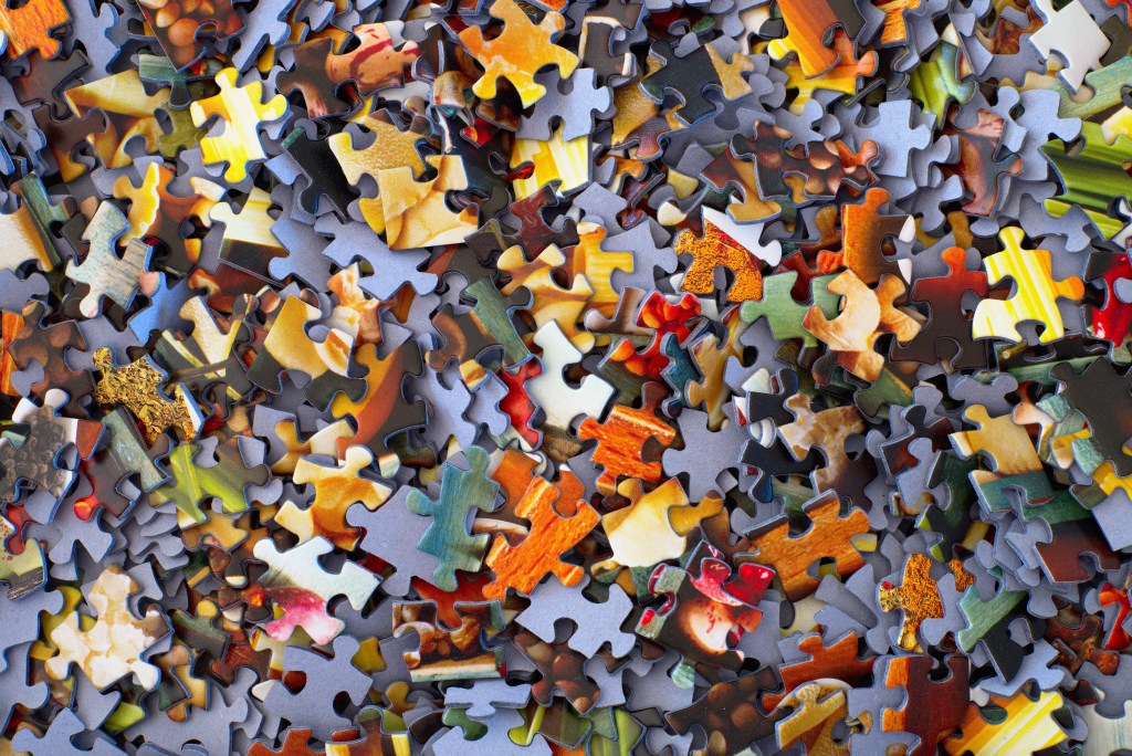 A pile of colorful jigsaw pieces